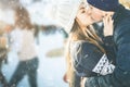 Kissing couple, girls and boy ice skating outdoor at rink Royalty Free Stock Photo