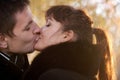 Kissing couple on leaves background at sunshine weather Royalty Free Stock Photo