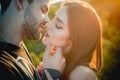 Kissing couple in love. Portrait of young beautiful couple kiss in an autumn sunny day.