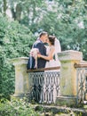 Kissing newlyweds on the old balcony. Full-length view. Royalty Free Stock Photo