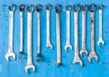 Kit of adjustable grunge metallic wrench with dirty blue b Royalty Free Stock Photo