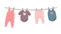 kit of newborn clothes on the cloth rope