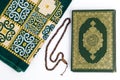 Kitab Al - Qur\'an, Muslim prayer rugs, and tasbih on white background