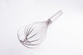 Kitche whisk or egg beater isolated on white background; sensation of fresh and clean kitchen Royalty Free Stock Photo