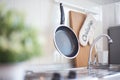 Kitchen accessories hanging in the roof rail on the white wall Royalty Free Stock Photo