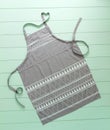 Kitchen apron of gray color on turquoise background Royalty Free Stock Photo