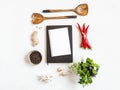 Kitchen background with open cookbook for recipes and various spices and herbs on a light background. Top view. Copy space Royalty Free Stock Photo