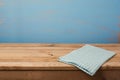 Kitchen background with tablecloth on empty wooden table over painted blue wall Royalty Free Stock Photo