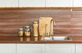 kitchen background with kitchen utensils standing on wooden countertop, blank space for a text, front view Royalty Free Stock Photo