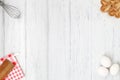 Kitchen background. White wooden table with eggs, cookies and copy space. Frame, flat lay Royalty Free Stock Photo