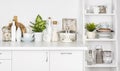 Kitchen bench and shelf with various utensils on white background