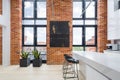 Kitchen with big windows and brick walls Royalty Free Stock Photo