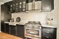 a kitchen with black cabinets and a stainless steel oven Royalty Free Stock Photo