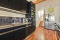 a kitchen with black cabinets and a stainless steel refrigerator