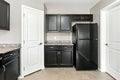 Kitchen with a black refrigerator and cabinets Royalty Free Stock Photo
