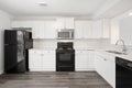 A kitchen with a black stove and a white refrigerator Royalty Free Stock Photo