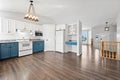 Kitchen with blue cabinets and a white refrigerator Royalty Free Stock Photo