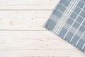 Kitchen blue checkered tablecloth on rustic wood background template. White wooden table with blue checkered pattern Royalty Free Stock Photo