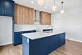 Kitchen with a blue island and white countertops Royalty Free Stock Photo