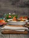 Kitchen board with cloth on wooden table with variety food