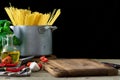 Kitchen board with set of ingredients for cooking Italian pasta Royalty Free Stock Photo