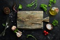 Kitchen board and spices with vegetables. Dishes menu. Free copy space. Royalty Free Stock Photo