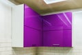 Kitchen Cabinet with chipboard shelves with closed doors purple Royalty Free Stock Photo