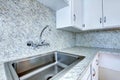 Kitchen cabinet with steel sink and granite counter top Royalty Free Stock Photo