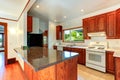 Kitchen cabinets with granite tops and white appliances