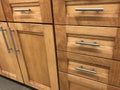 Kitchen cabinets made of natural wood maple with chrome handles