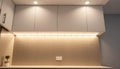 Kitchen cabinets with under-cabinet lighting, showcasing kitchen illumination and modern design Generative AI Royalty Free Stock Photo