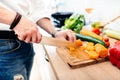 Kitchen chef, master cook preparing dinner. details of knife cutting vegetables in modern kitchen Royalty Free Stock Photo