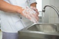 Kitchen chef washing hands in kitchen Royalty Free Stock Photo