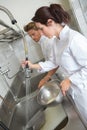 Kitchen clerks washing dishes Royalty Free Stock Photo