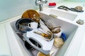 Kitchen conceptual image. Dirty sink with many dirty dishes. Royalty Free Stock Photo