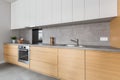 Kitchen with concrete worktop and wooden furniture Royalty Free Stock Photo
