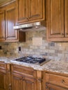 Kitchen cooktop and cabinets angle view