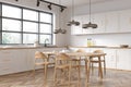 Kitchen corner and dining room combo in white. Corner view