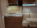 Kitchen corner and rear seats with dining table in modern german camper van Eura Mobil Integra 760 EF