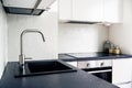 Kitchen counter top, faucet, water tap and sink. White and black Scandinavian interior design in modern apartment and home. Royalty Free Stock Photo