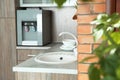 Kitchen counter with water cooler, sink and clean dishes Royalty Free Stock Photo