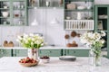 Kitchen countertop with flowers in bucket and jar