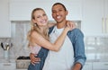 Kitchen, couple and hug portrait with love, care and smile at home ready for meal cooking. Interracial happy couple