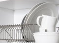 Kitchen cupboard with a lattice for dishes, with a white and black plate, cups Royalty Free Stock Photo