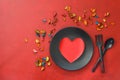 Kitchen cutlery on plate with gift and colorful rose. Happy Valentines Day scene Royalty Free Stock Photo