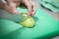 Kitchen cutting actions with knife, avocado and hands. Royalty Free Stock Photo
