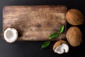 Kitchen cutting board and coconut with green leaves Royalty Free Stock Photo