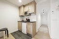 Kitchen with dark gray countertops, wood cabinets, and built-in Royalty Free Stock Photo