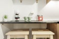 Kitchen with dark gray wooden countertops with cups of coffee