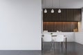 Kitchen with dark wood furniture, blank wall